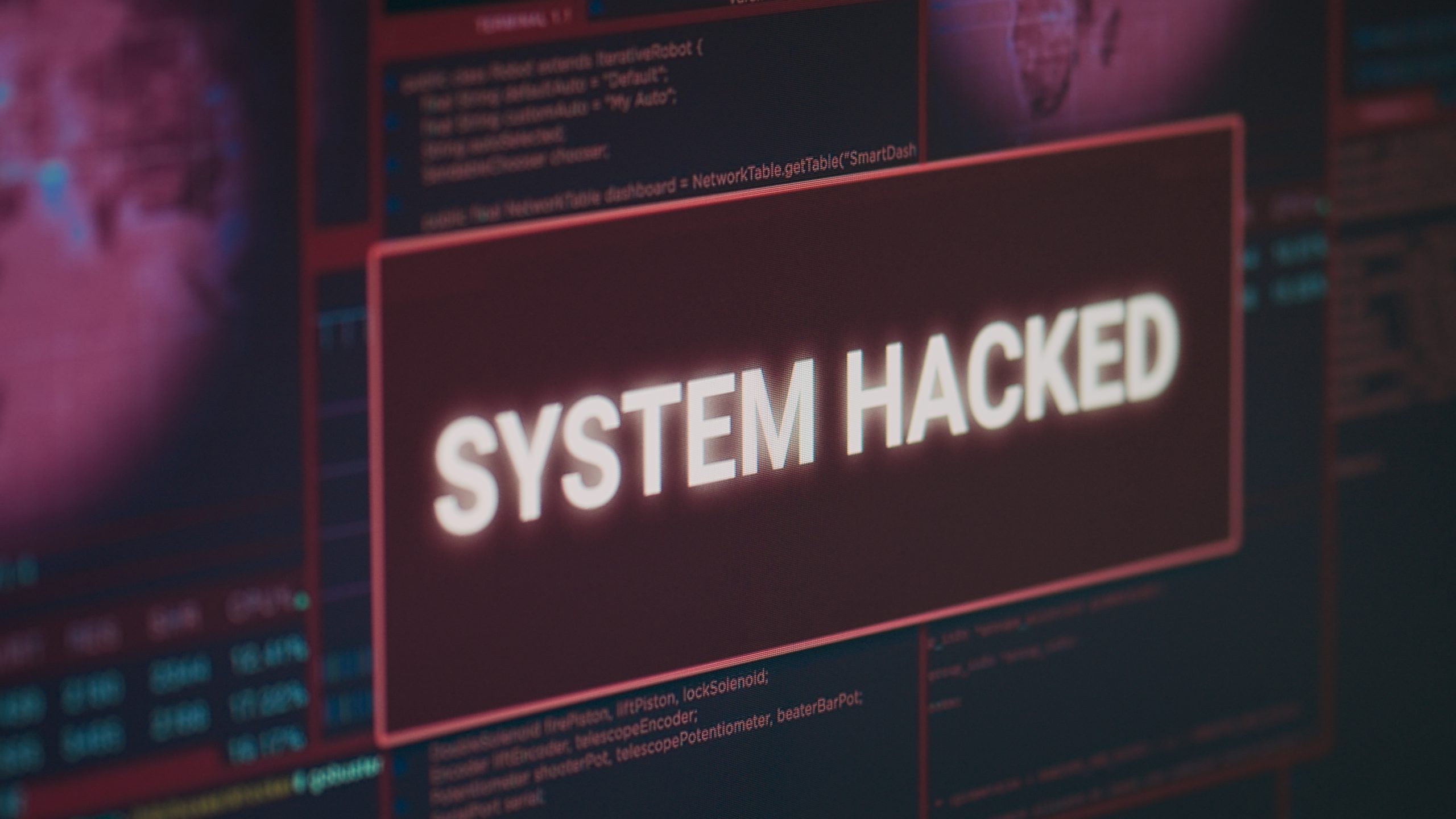 Computer monitor showing hacked system alert