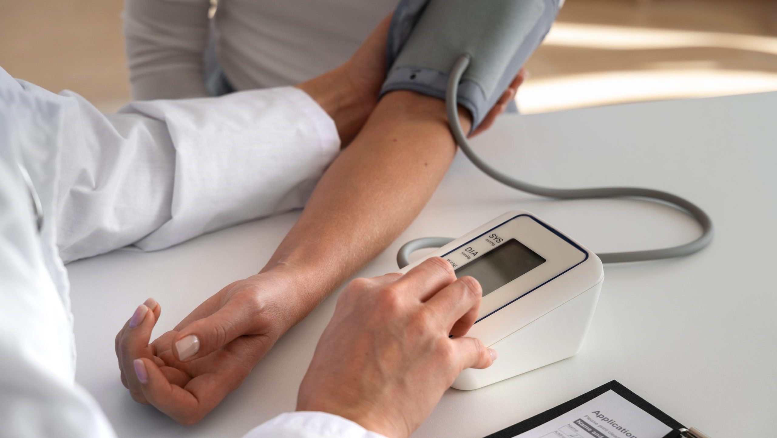 person getting her blood pressure checked, Effective High Blood Pressure Control Reduces Dementia Risk